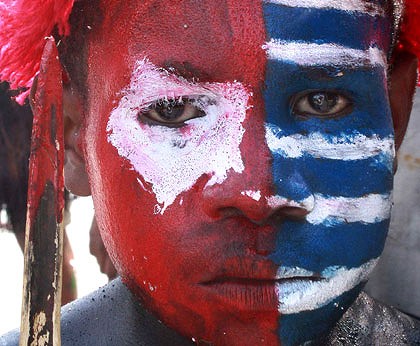 West Papuan protester's face, painted as the banned separatist flag, 8 July 2010