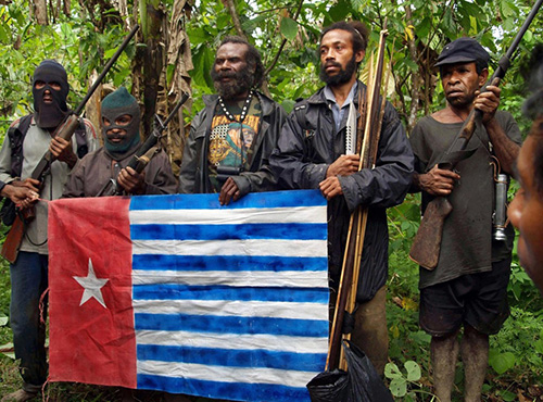 Members of the separatist Free Papua Movement (OPM) appear in front of media in the jungles of Indonesia’s Papua province on July 25, 2009